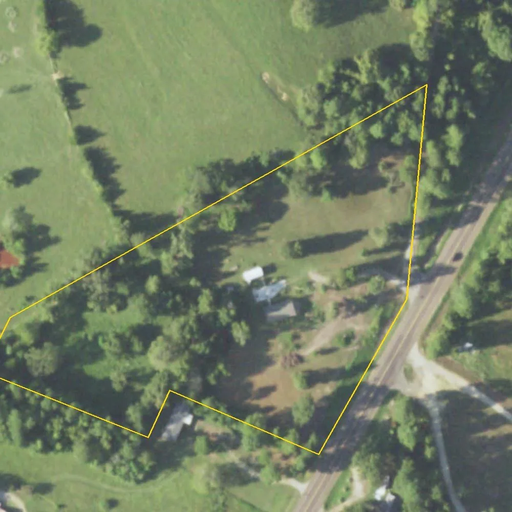 The land at 1208 County Road 3199 from the air, outlined in yellow, with Highway 7 along its side.